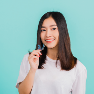 girl holding an invisalign