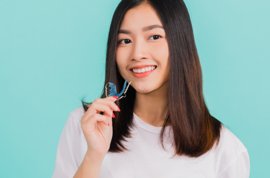 girl holding an invisalign